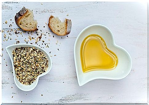 Bread, seeds and oil in heart-shaped bowls
