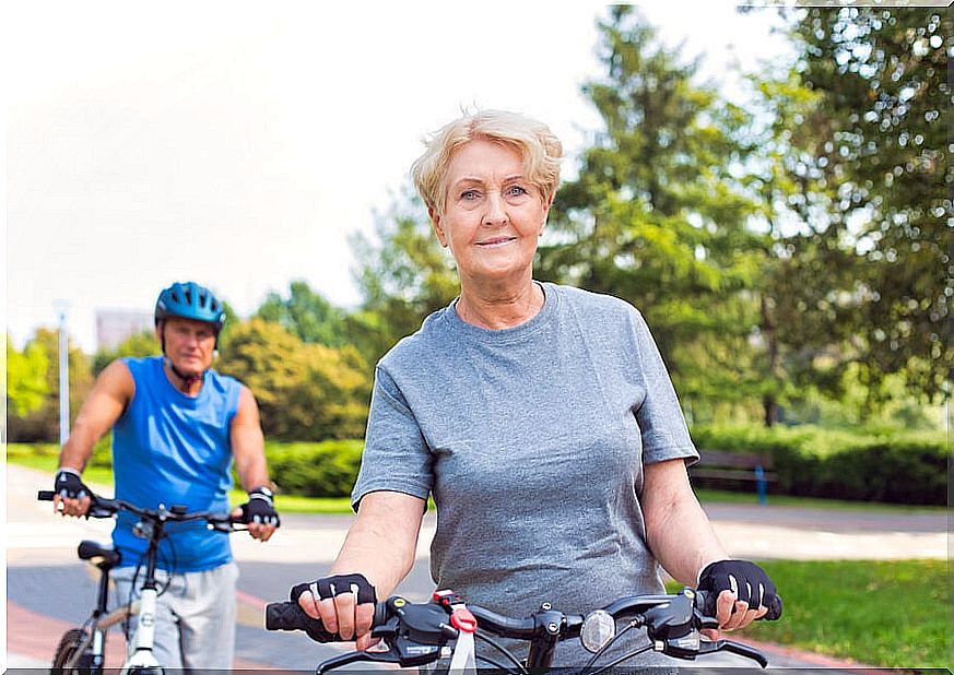 Older man and woman riding bicycles.