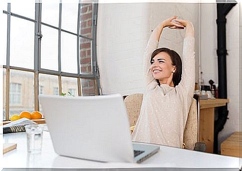 Woman at work doing stretching to relieve back pain
