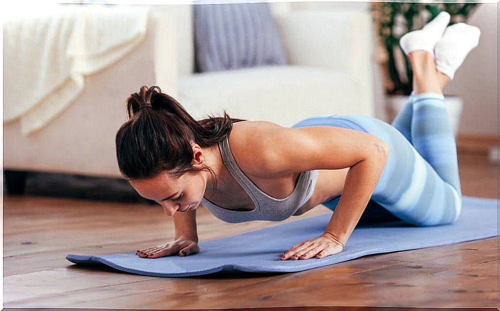 Woman exercising on mat.