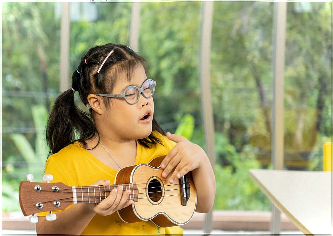 Girl with Down syndrome in music therapy.