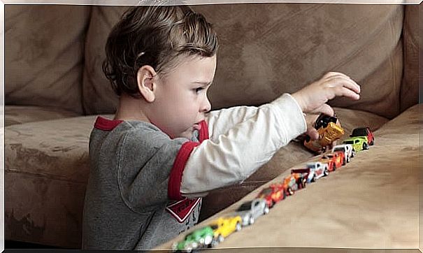 Child playing with cars.