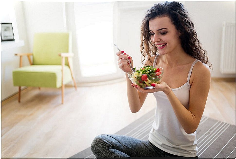 Woman eating a salad.