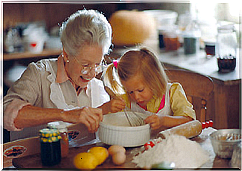 grandmother cooking with her granddaughter