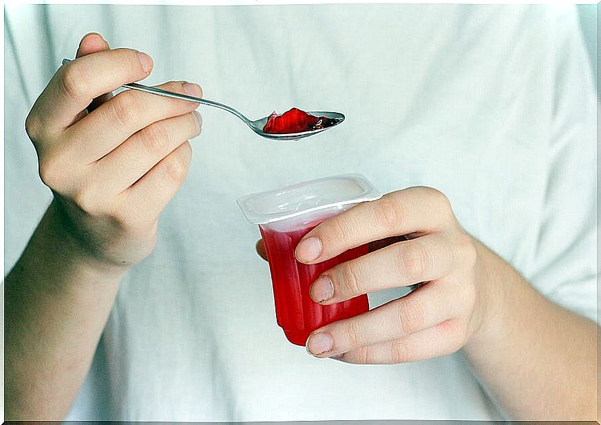 Woman catching a spoonful of jelly.
